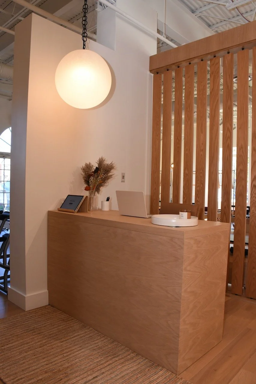 Great Falls Movement Center reception area with warm wood and dried flowers.